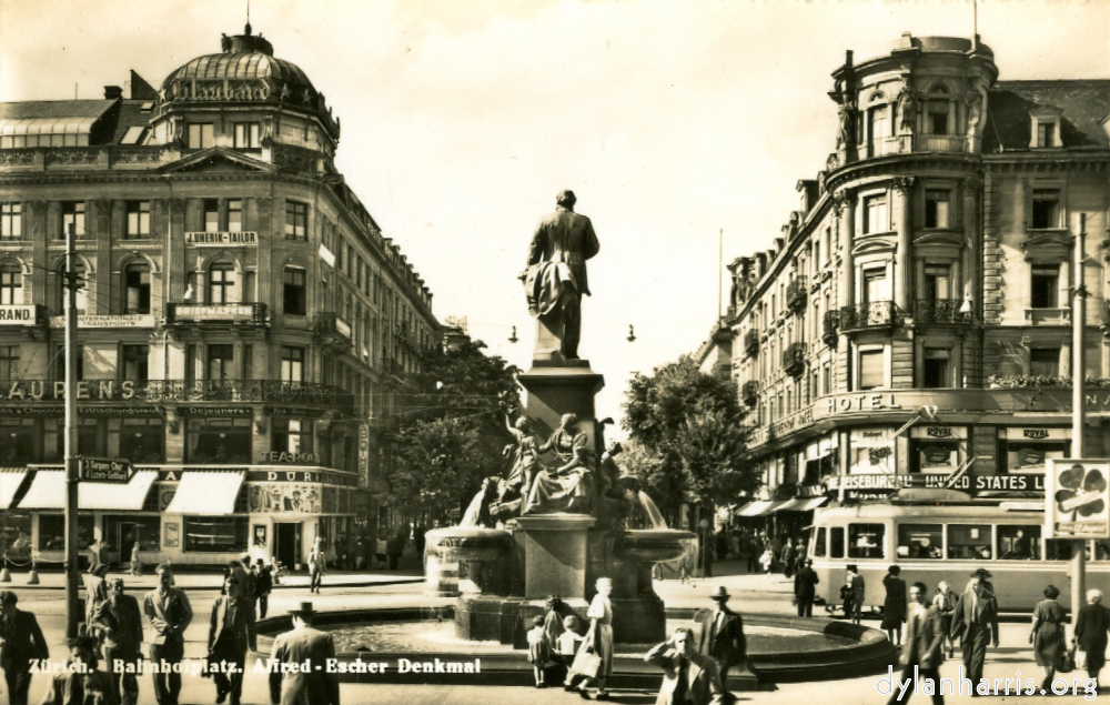 image: Postcard: Z&uuml;rich. Bahnhofplatz. Afred-Escher Denkmal [[ The Bahnhofstrasse from the Station. ]]